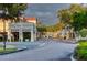 Picturesque street view lined with trees and charming buildings featuring Spanish-style architecture at 3775 Via Mazzini Ct, Kissimmee, FL 34759