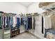 View of walk-in closet with carpet and extensive built-in storage and shelving at 3775 Via Mazzini Ct, Kissimmee, FL 34759