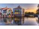 Stunning water view showcasing upscale community buildings reflected in the serene water at sunset at 3775 Via Mazzini Ct, Kissimmee, FL 34759