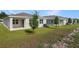 Exterior shot of the back of the house with lawn and trees at 4075 Bannock Ave, Tavares, FL 32778