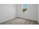 Bright and airy bedroom with carpeted flooring and a large window with outside views at 4075 Bannock Ave, Tavares, FL 32778