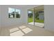 Sun filled bedroom with hardwood style flooring and sliding doors to a patio at 4075 Bannock Ave, Tavares, FL 32778