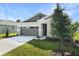 Charming home featuring stone accents, a gray garage door, and a well-manicured lawn at 4075 Bannock Ave, Tavares, FL 32778