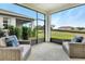 Covered patio featuring comfortable seating overlooking a spacious backyard and new home construction at 4075 Bannock Ave, Tavares, FL 32778