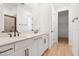 Modern bathroom featuring dual sinks and white cabinets at 4076 Bannock Ave, Tavares, FL 32778