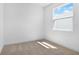 Bright bedroom features a large window providing natural light and neutral wall-to-wall carpeting at 4076 Bannock Ave, Tavares, FL 32778