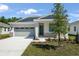 Charming single-Gathering home with a gray garage door and stone accents at 4076 Bannock Ave, Tavares, FL 32778