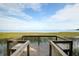 Picturesque lake view from dock with seating overlooking the tranquil water at 4076 Bannock Ave, Tavares, FL 32778