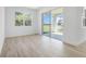 Bright living room with wood-look flooring and sliding glass doors at 4076 Bannock Ave, Tavares, FL 32778