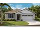 Charming single-story home featuring a two-car garage, landscaped yard and modern architectural details at 4083 Bannock Ave, Tavares, FL 32778