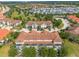 Aerial view of a townhome community with pools, lush landscaping, and tile roofs at 4751 Terrasonesta Dr, Davenport, FL 33837