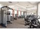 Well-equipped community gym with cardio and weight training equipment, mirrors, and natural lighting at 4751 Terrasonesta Dr, Davenport, FL 33837