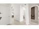 Hallway featuring neutral tile flooring, arched mirror, and contemporary lighting at 4751 Terrasonesta Dr, Davenport, FL 33837
