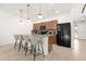 Open-concept kitchen features an island with bar seating, modern lighting, and stainless appliances at 4751 Terrasonesta Dr, Davenport, FL 33837
