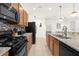 Modern kitchen featuring stainless steel appliances, granite countertops, and tiled backsplash at 4751 Terrasonesta Dr, Davenport, FL 33837