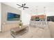 Open-concept living room with modern furnishings, media console, and kitchen island at 4751 Terrasonesta Dr, Davenport, FL 33837