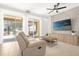 Modern living room with a sleek TV wall, comfortable seating, and access to the outdoor living space at 4751 Terrasonesta Dr, Davenport, FL 33837