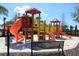 Community playground featuring multiple slides and play areas on a soft sand base at 4751 Terrasonesta Dr, Davenport, FL 33837