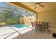 Enclosed pool area offers outdoor dining and a private pool surrounded by lush landscaping and privacy at 4751 Terrasonesta Dr, Davenport, FL 33837
