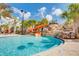 Community pool area features a fun waterslide, waterfalls, and plenty of lounge chairs for relaxation at 4751 Terrasonesta Dr, Davenport, FL 33837