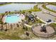 Aerial view of community pool, playground, parking, and lake at 5140 Four Strand Ct, St Cloud, FL 34772