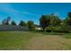 Large grassy backyard with a white fence and some trees beyond it at 5140 Four Strand Ct, St Cloud, FL 34772
