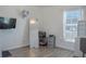 Functional bedroom features a large mirror, black TV, study space, laminate flooring and a large window at 5140 Four Strand Ct, St Cloud, FL 34772