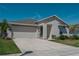 Charming home boasts a two-car garage, well-manicured lawn and landscaping, and a concrete driveway at 5140 Four Strand Ct, St Cloud, FL 34772