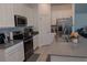 Well-equipped kitchen featuring stainless steel appliances, white cabinetry, and a spacious island with a sink at 5140 Four Strand Ct, St Cloud, FL 34772