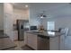 Kitchen island featuring stainless steel appliances, a sink, white cabinets, and tile floors at 5140 Four Strand Ct, St Cloud, FL 34772