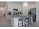 Bright kitchen featuring stainless steel appliances, white cabinets, and a large center island with barstool seating at 5140 Four Strand Ct, St Cloud, FL 34772
