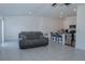 Bright, open living space with tile floors and open kitchen with barstool seating at 5140 Four Strand Ct, St Cloud, FL 34772