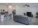 Open-concept living space with view of kitchen island, tile floors, and ceiling fan at 5140 Four Strand Ct, St Cloud, FL 34772