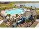 Aerial shot of a sparkling community pool with lake view at 5140 Four Strand Ct, St Cloud, FL 34772