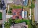 Birds eye view of single-story home with a covered pool, solar panels, and well-maintained landscaping at 6017 Hickory Grove Ln, Port Orange, FL 32128