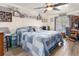A cozy bedroom featuring a ceiling fan, natural light, and stylish decorations at 6017 Hickory Grove Ln, Port Orange, FL 32128