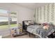 Bright bedroom with natural light, featuring a cozy bed, a window, and tasteful decorations at 6017 Hickory Grove Ln, Port Orange, FL 32128