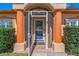 Inviting front door with decorative pillars, a tiled entryway, and lush green shrubbery on a sunny day at 6017 Hickory Grove Ln, Port Orange, FL 32128