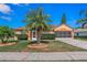 Beautiful single-story house with lush landscaping, a well-manicured lawn, and an attached screened garage at 6017 Hickory Grove Ln, Port Orange, FL 32128