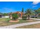 Charming home featuring landscaped front yard with mature palm trees and a welcoming entrance at 6017 Hickory Grove Ln, Port Orange, FL 32128