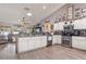 Well-lit kitchen with gray countertops, wooden floors, modern appliances, and open access to the living space at 6017 Hickory Grove Ln, Port Orange, FL 32128