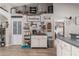 Bright kitchen with white cabinets, farmhouse decor, wood-look floors, and a functional coffee bar area at 6017 Hickory Grove Ln, Port Orange, FL 32128