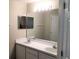 Bathroom featuring a double sink vanity, large mirror, and ample lighting at 610 Yak Ct, Kissimmee, FL 34759