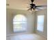 Well-lit bedroom with ceiling fan, neutral walls, and large window at 610 Yak Ct, Kissimmee, FL 34759