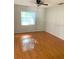 Bedroom featuring hardwood flooring, light-filtering blinds, and a ceiling fan at 610 Yak Ct, Kissimmee, FL 34759