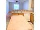 Kitchen featuring an island, wooden cabinets, and an open view into the living room at 610 Yak Ct, Kissimmee, FL 34759