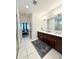Bathroom featuring double sink vanity, tiled floor and walk-in shower at 6608 Harper Way, Harmony, FL 34773