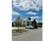 Exterior of community building in a parking lot with a well-maintained lawn and beautiful blue sky at 6608 Harper Way, Harmony, FL 34773