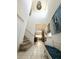 The foyer boasts soaring ceilings, tile floors, a bench, and stairs leading to the upper level at 6608 Harper Way, Harmony, FL 34773