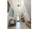 The foyer features a high ceiling, tile floor, and a bench with decorative pillows at 6608 Harper Way, Harmony, FL 34773